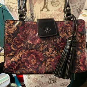 PATRICI NASH SHOULDER BAG. BLACK LEATHER WITH MARROON & LIGHT ORANGEISH FLOWERS